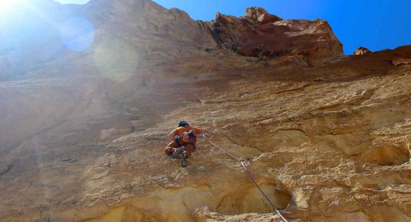 a person is high up on a rock face as they climb higher